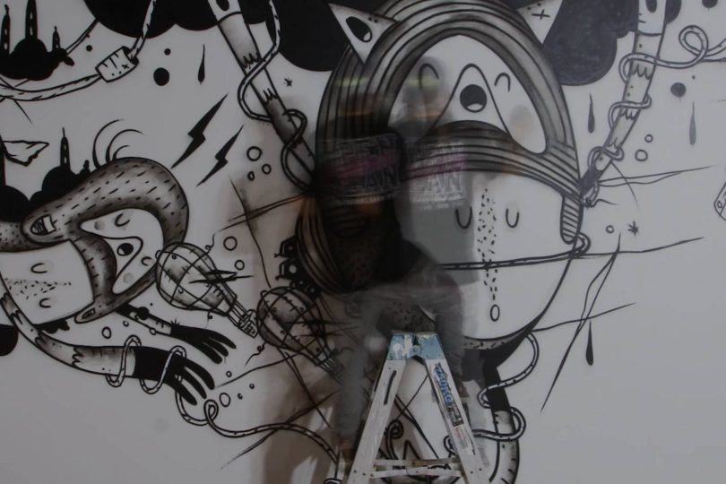 Action shot of Cracked Ink spraying an artwork